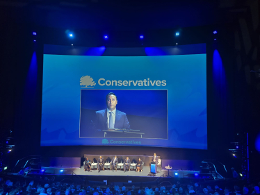 The Conservative Party Leadership contenders on a large stage.