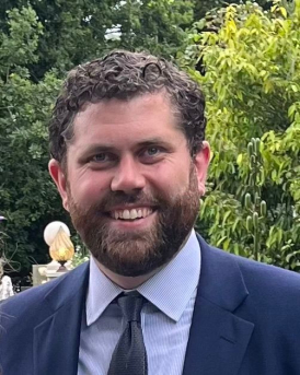 Headshot of Paul Startin wearing a blue suit.